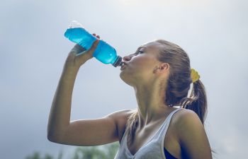 Athlete woman drinking energy drink during her work out