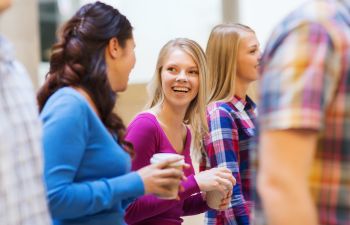 smiling teenagers chatting during a school break