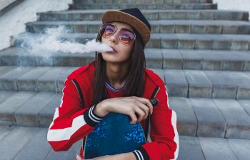 vaping teen girl with a skateboard 